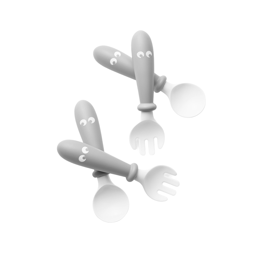 Two gray utensils with eyes, one spoon and one fork, featuring playful, cartoon-style designs.