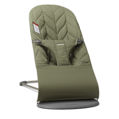 Olive-green quilted baby bouncer with padded harness and metal frame on a rounded gray base.