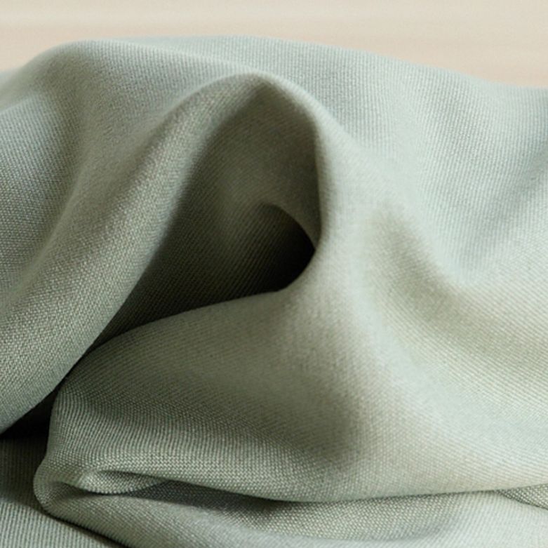 Soft brushed woven in light green from BabyBjörn