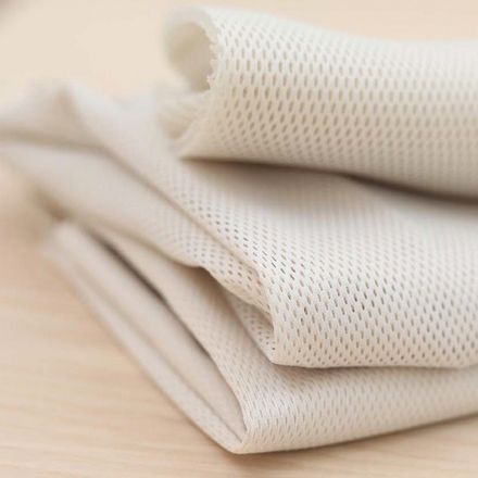 Airy mesh fabric in cream colour from BabyBjörn