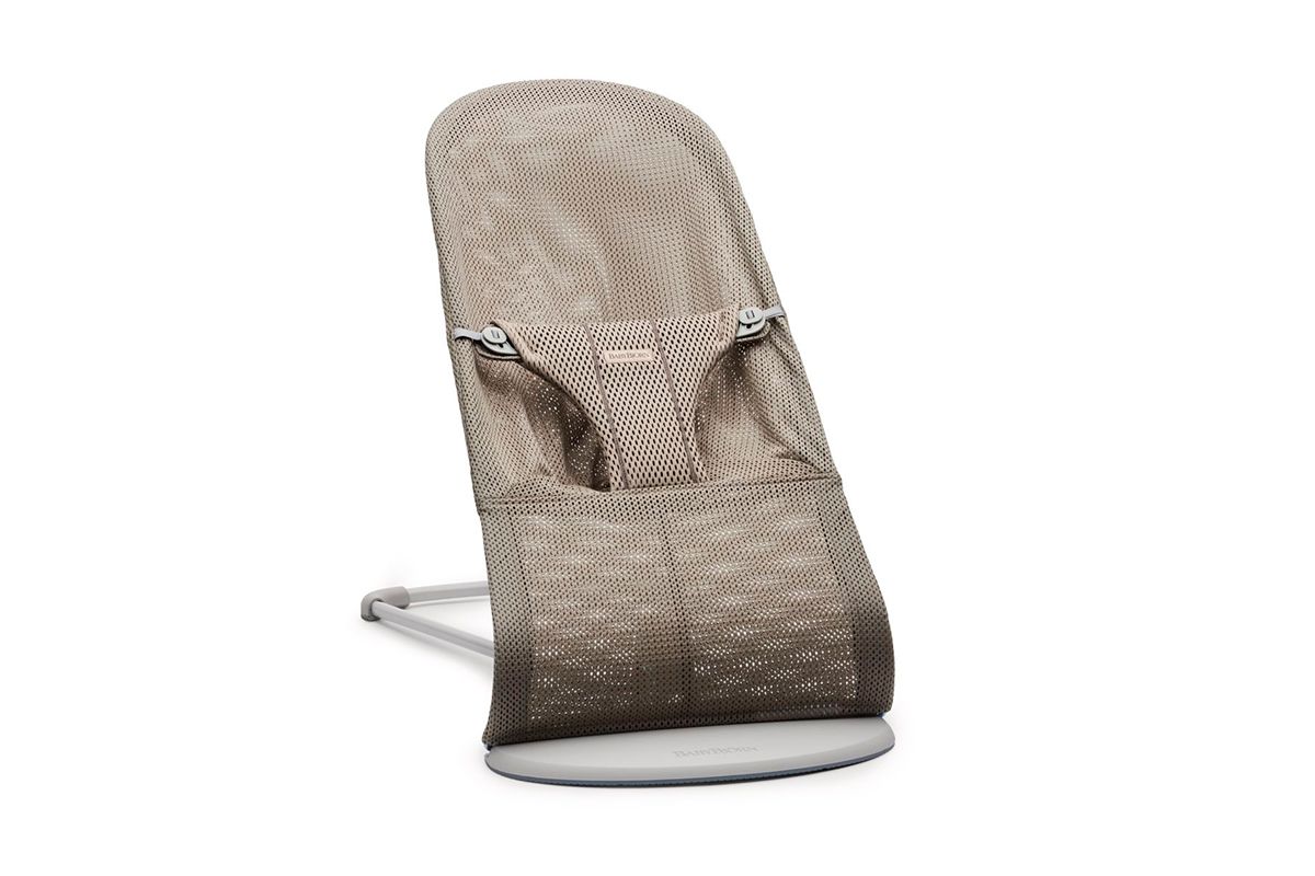 A beige mesh baby bouncer with a safety harness and a sleek metal frame, designed for comfort and support.