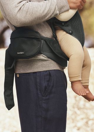 Elevate you baby wearing pocket pouch baby carrier in black BabyBjörn