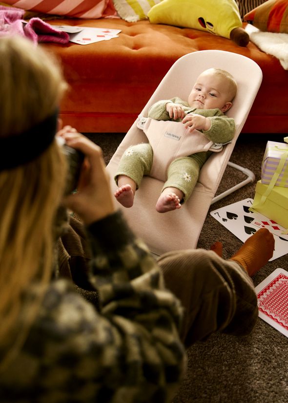 Bouncer Bliss in pink and kids playing in the living room
