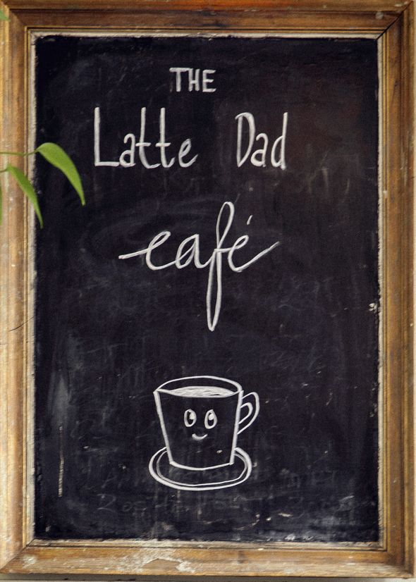 Chalkboard sign for "The Latte Dad Café" with a drawing of a smiling coffee cup beneath the text.