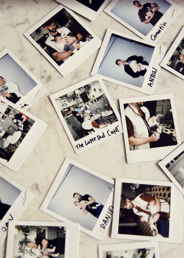 Scattered Polaroid photos of people holding babies, some labeled with names and "The Latte Dad Café," laid out on a marble surface.