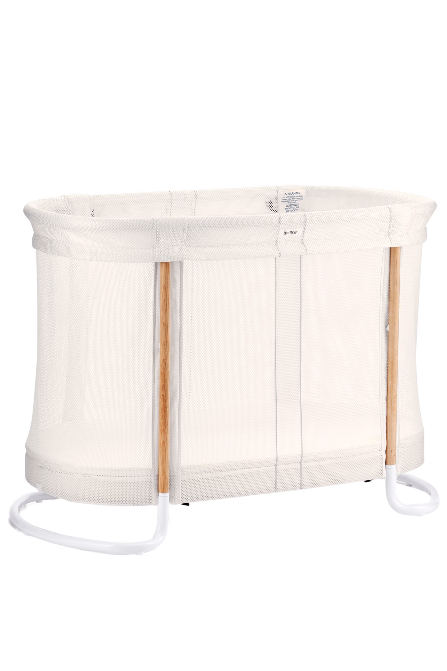 White baby crib with mesh side and wooden frame.