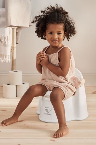 Foto de Potty Training. Little cute child girl sitting on a toilet. do  Stock