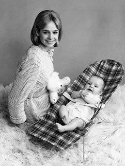 mother with baby in a baby bouncer