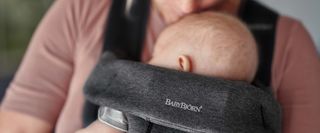 Baby sleeping in a baby carrier mini