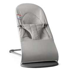 Gray baby bouncer with a sleek, modern design, featuring adjustable straps and a soft, padded seat on a sturdy base.