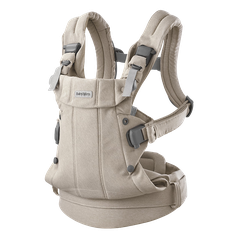Beige baby carrier with adjustable straps and buckles, designed for ergonomic support and comfort.