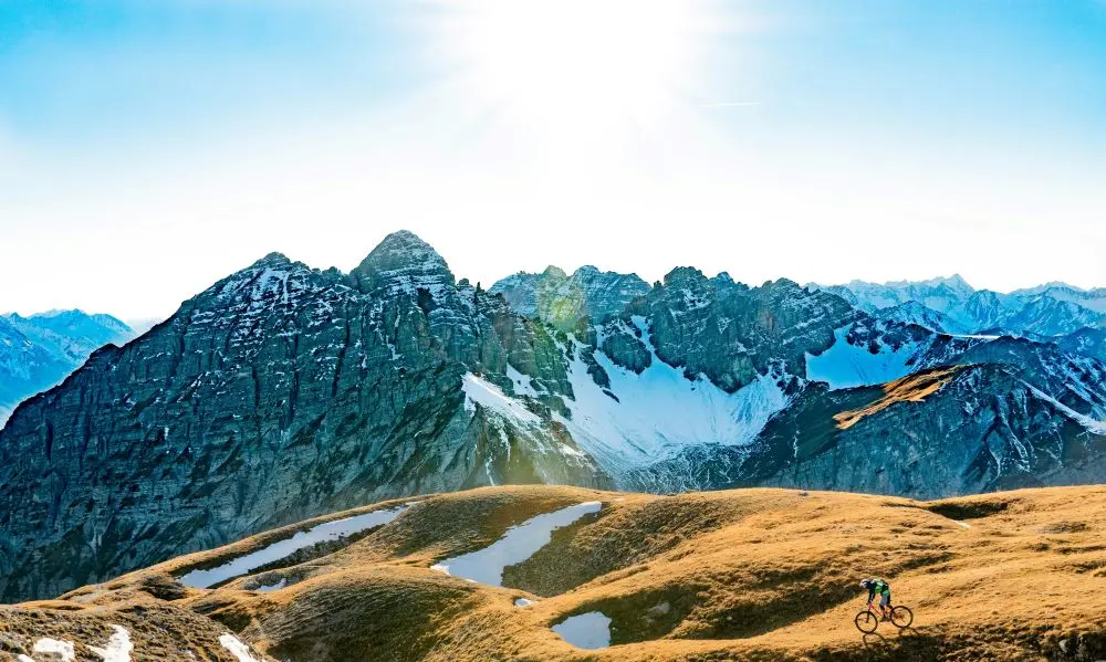 Man Biking Over Mountains