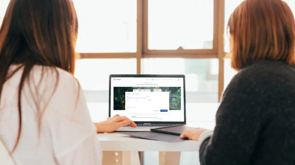 two women working on a laptop
