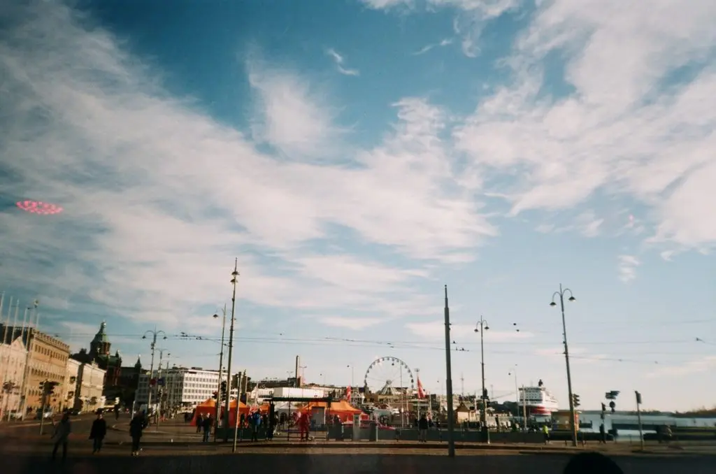 promenade by the sea with Ferris wheel in the background