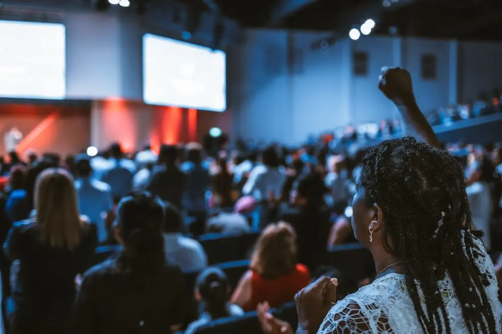 woman cheering at a conference talk