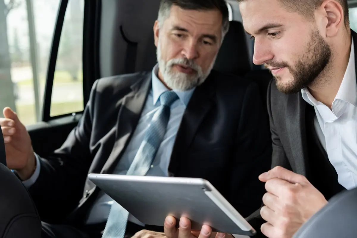 Zwei Maenner Im Auto Betrachten Tabletjpg