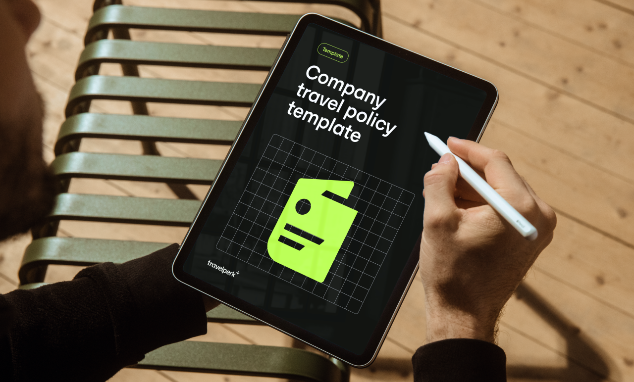 Man Using Tablet To Draft A Company Travel Policy