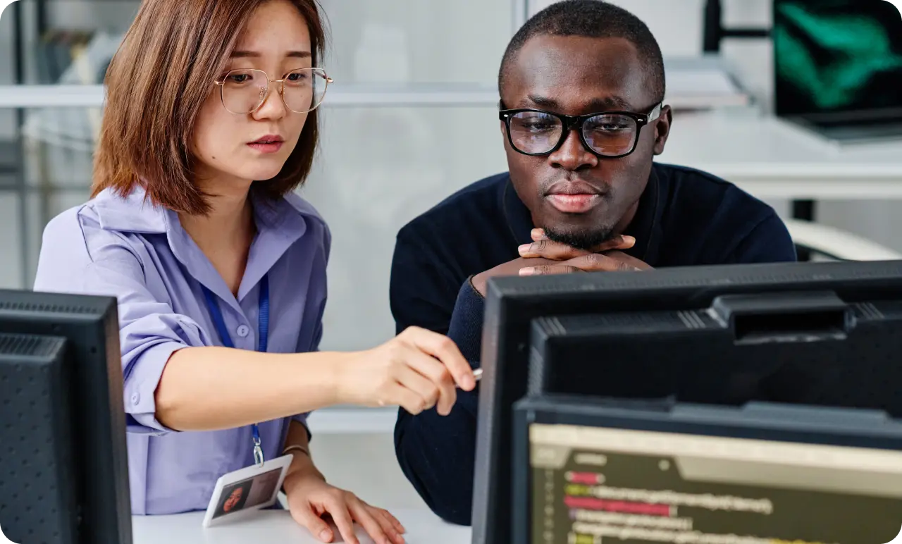 Two colleagues working together on a computer.