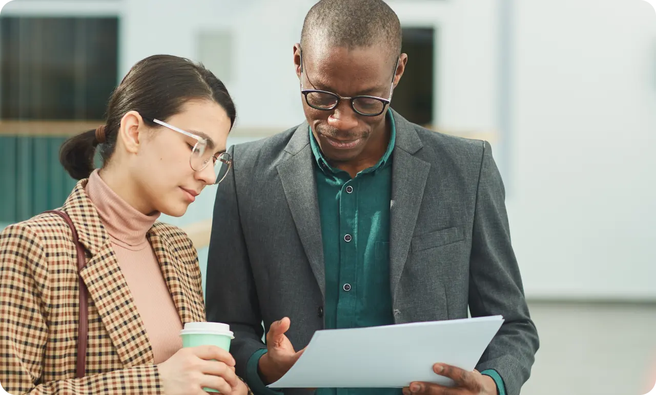 Two work colleagues looking at a report together.