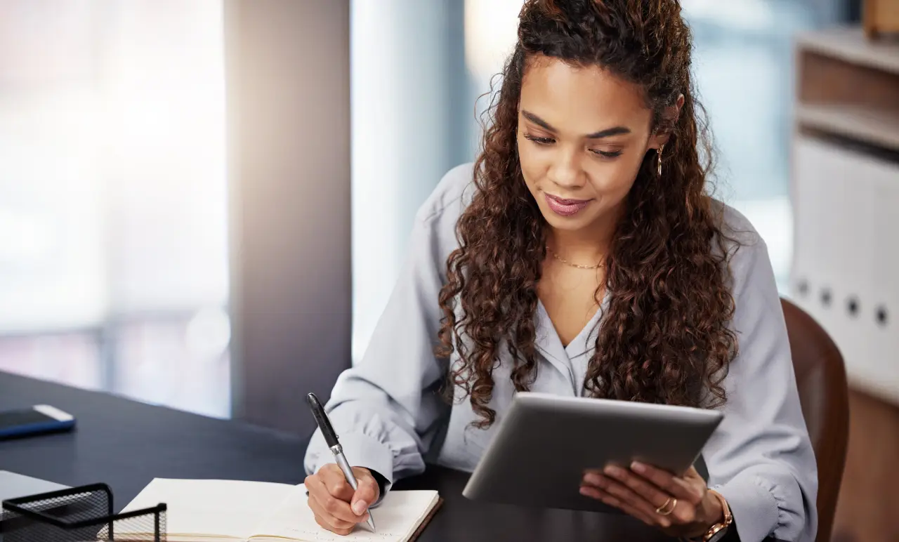 Women Working With Ipad And Notebook