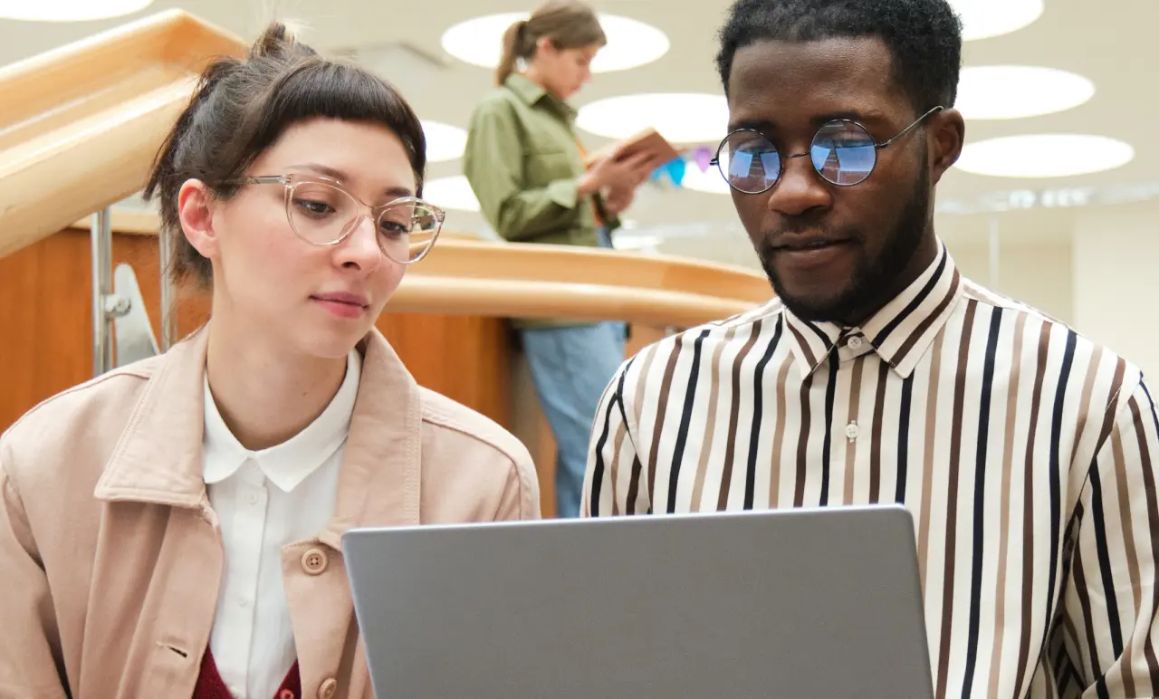 Two Colleagues Looking At Laptop
