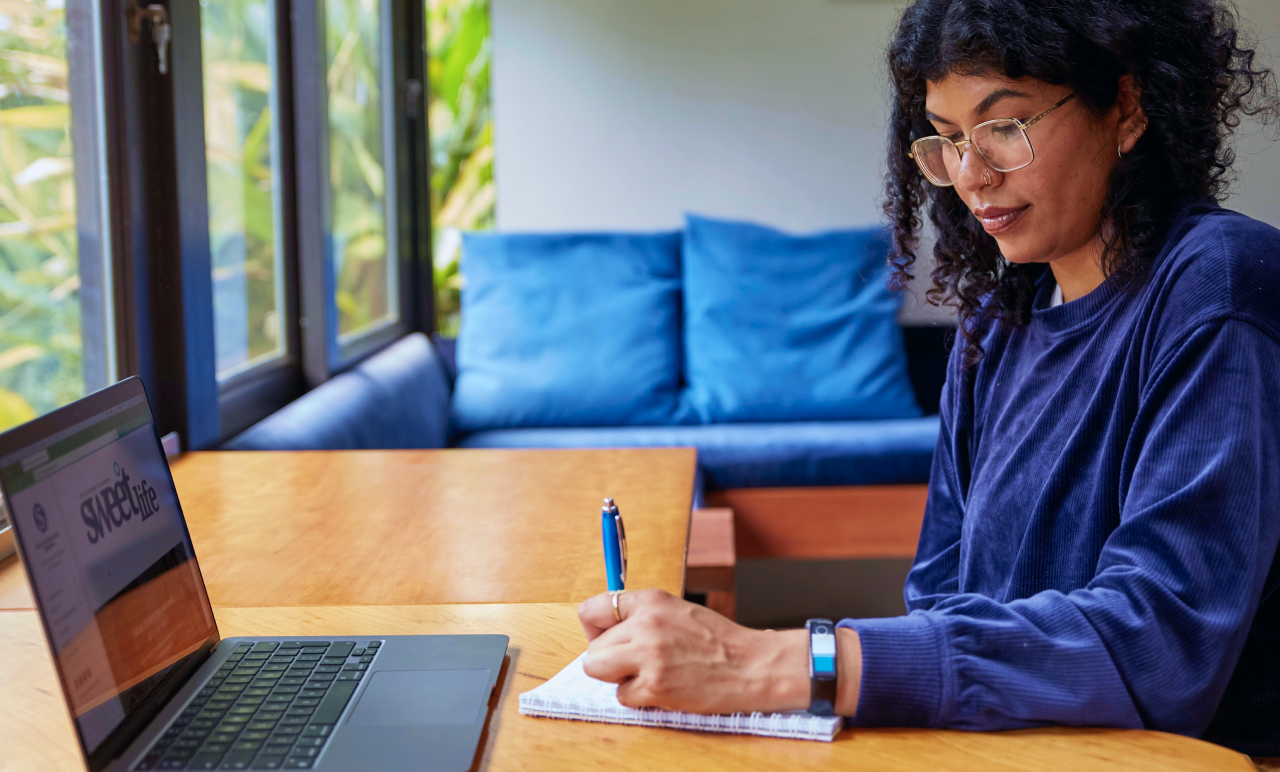 Woman Writing At Laptop