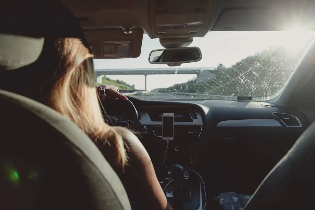 Woman Driving Car On Freeway Pexels Peter Fazekas 1386648