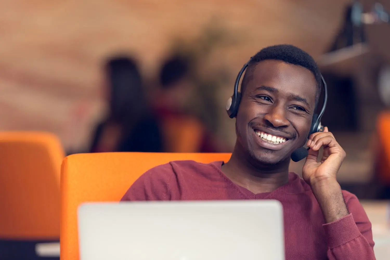 Man On Phone With Headset Via Laptop