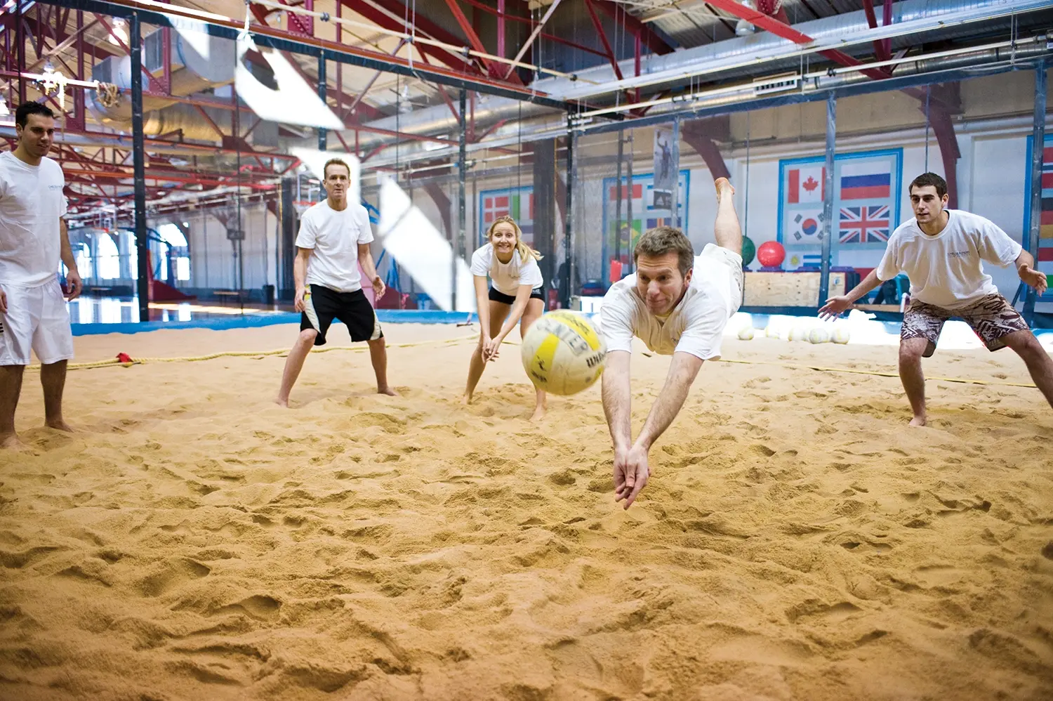 Group Playing Beach Volleyball