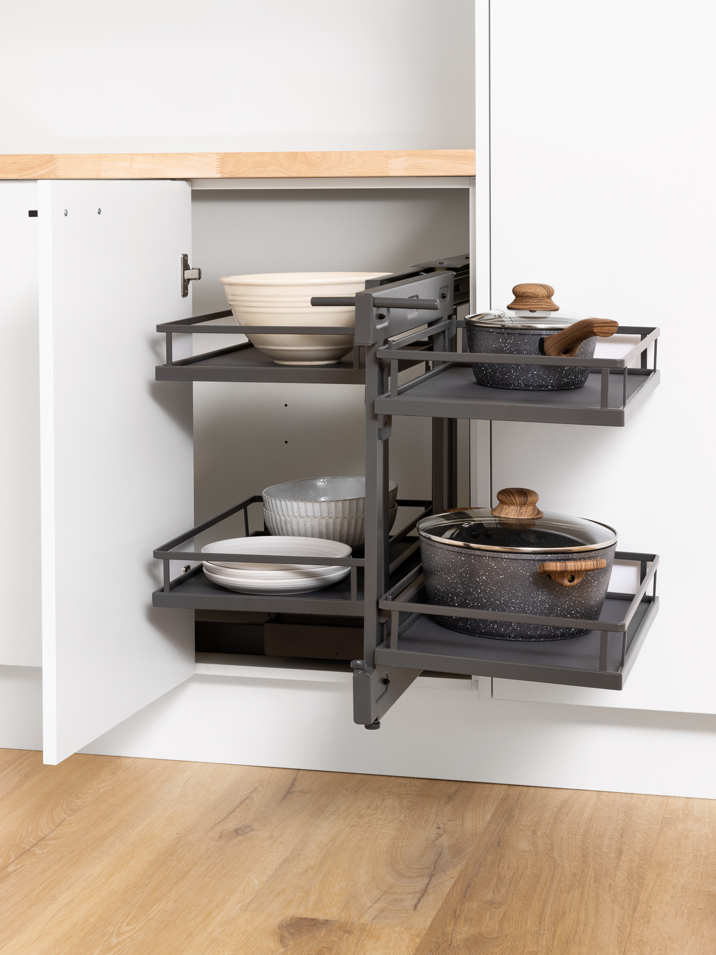 Corner Cabinet Storage with pull-out shelves, holding various pots and bowls.