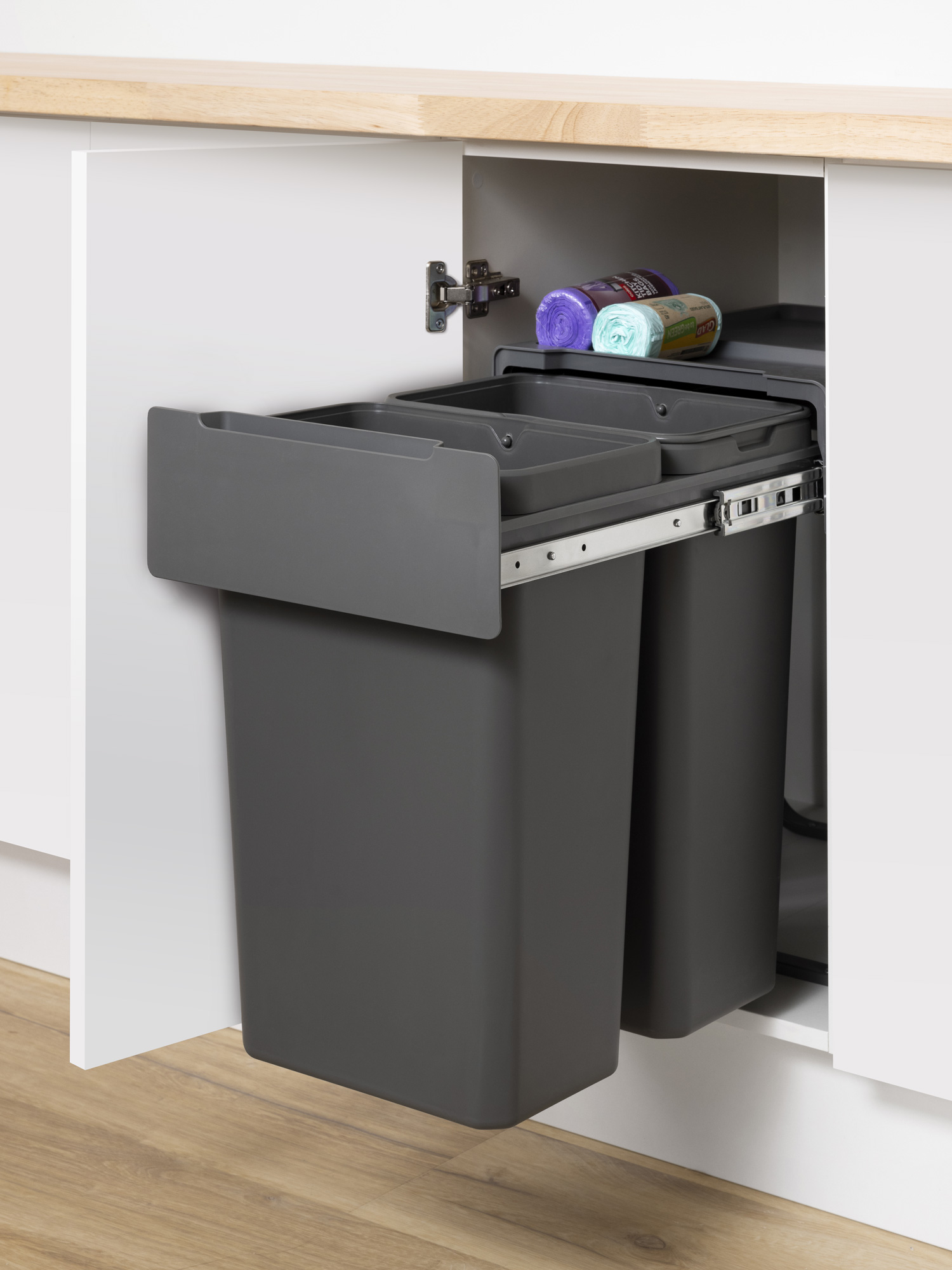 A Pullout Rubbish Bin with two grey recycling bins.
