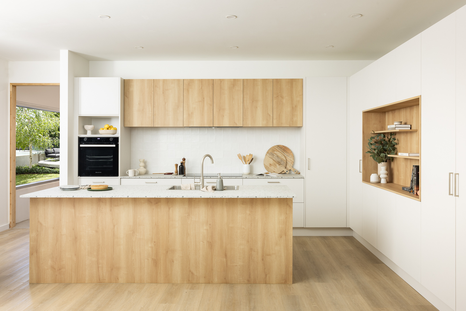 Timber-look kaboodle kitchen cabinetry paired with timber flooring