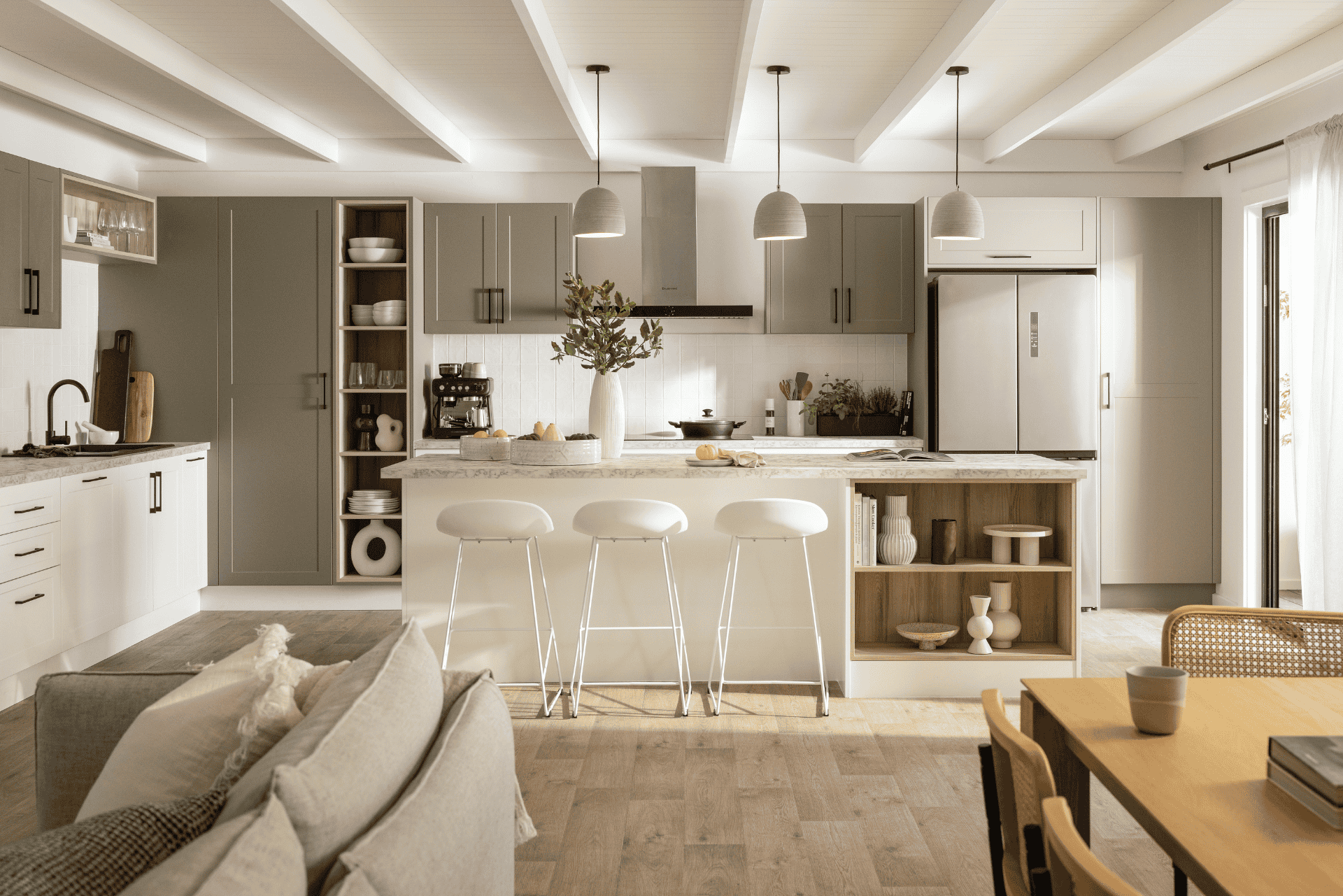Two tone kitchen with olive green wall cabinets and white base cabinets. A grand island bench is featured with stone-look benchtops.