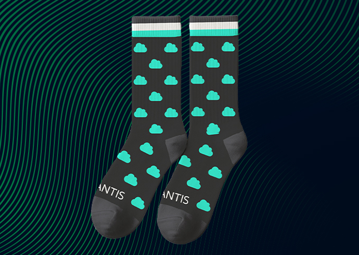 Black socks with teal cloud patterns and "ANTIS" text, set against a dark wavy striped background.