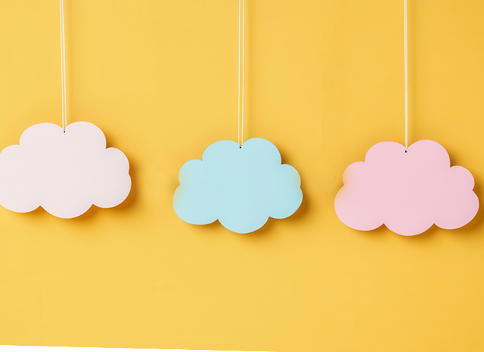 Three pastel cloud cutouts—white, blue, and pink—hanging against a bright yellow background.