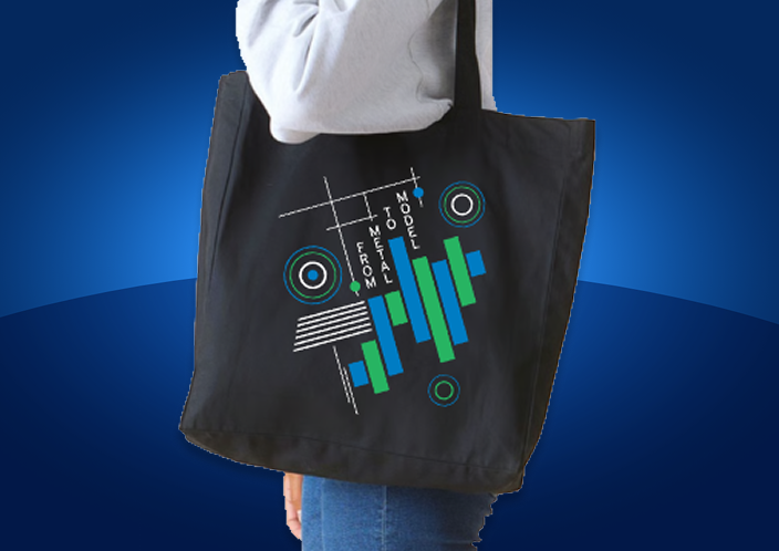 Person carrying a black tote bag with colorful geometric designs and text on a blue background.