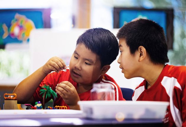 Two children playing with Lego at a Brick Club
