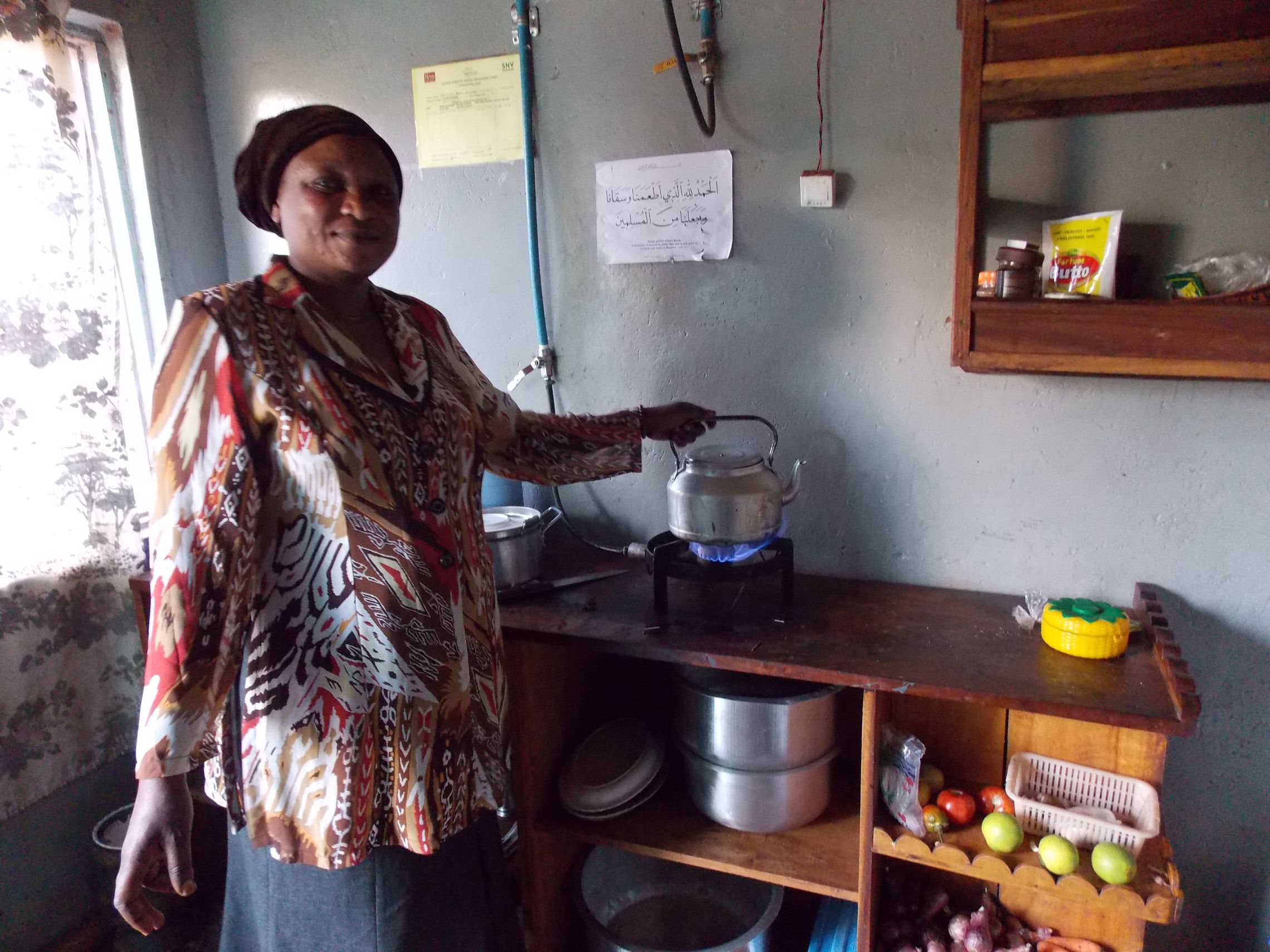 Zainab boils water with her biogas stove