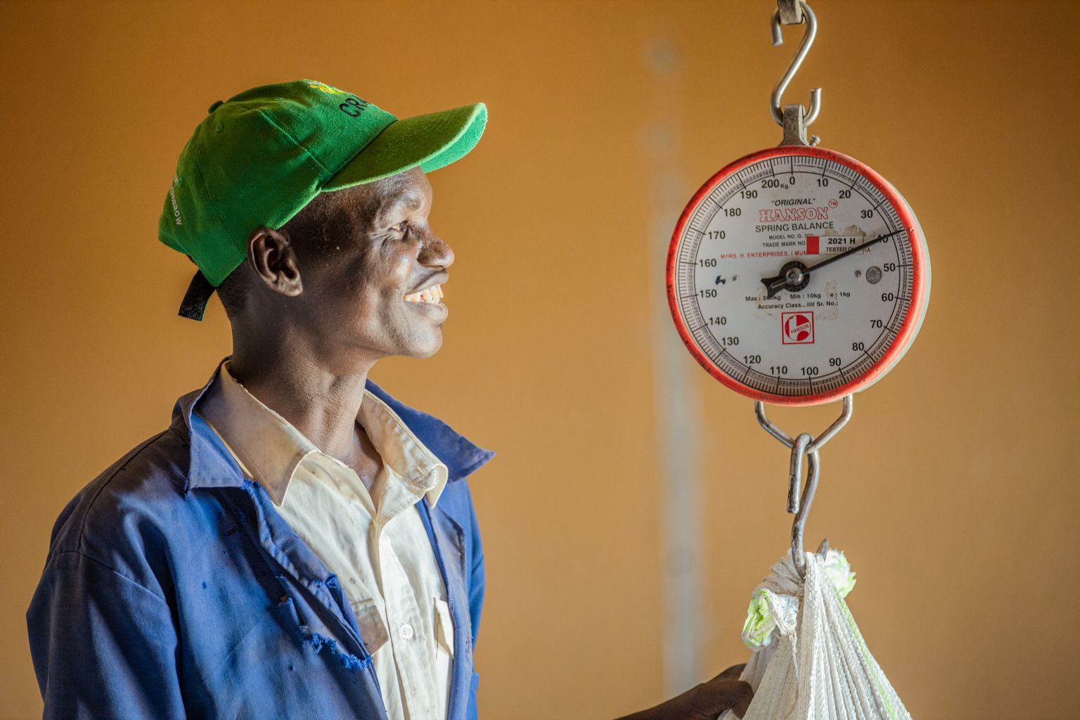 A man weighing a bag on a scale