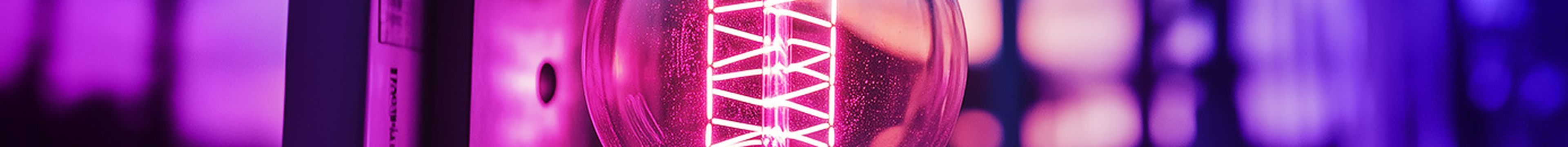 A halogen lightbulb with glowing filament on a blurry industrial background