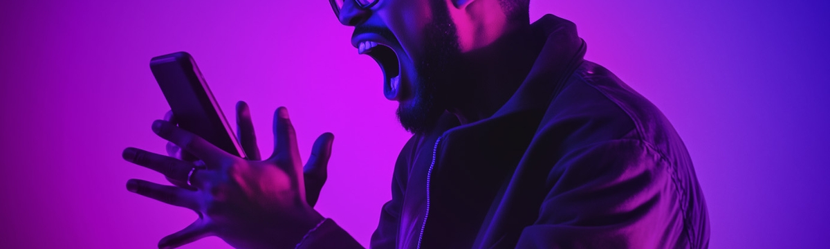 man screaming at his mobile phone studio lighting in pink and purples