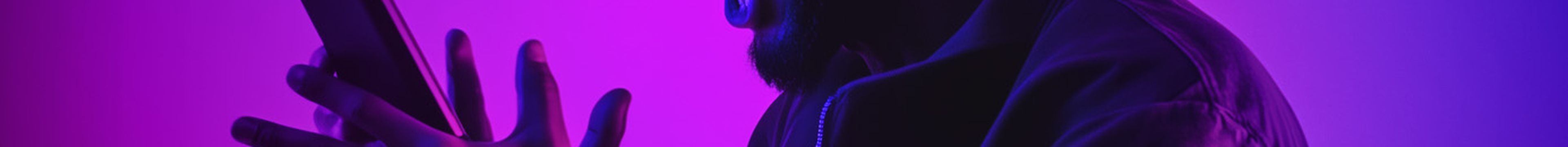 man screaming at his mobile phone studio lighting in pink and purples