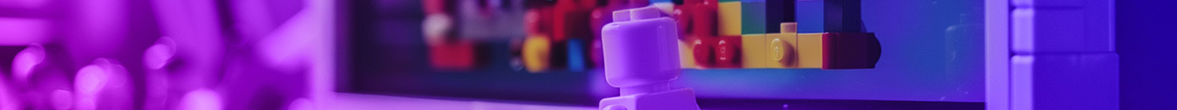 A lego figure building a website using lego on a lego computer monitor