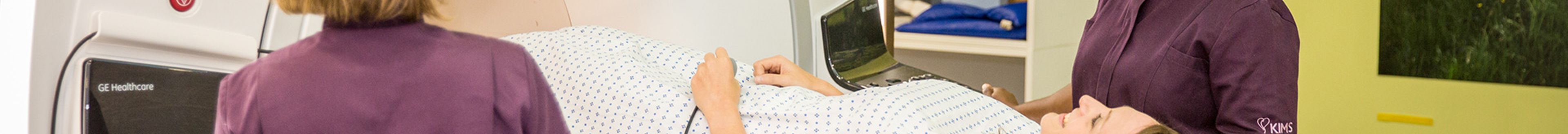 Nurses comforting patient before an examination.