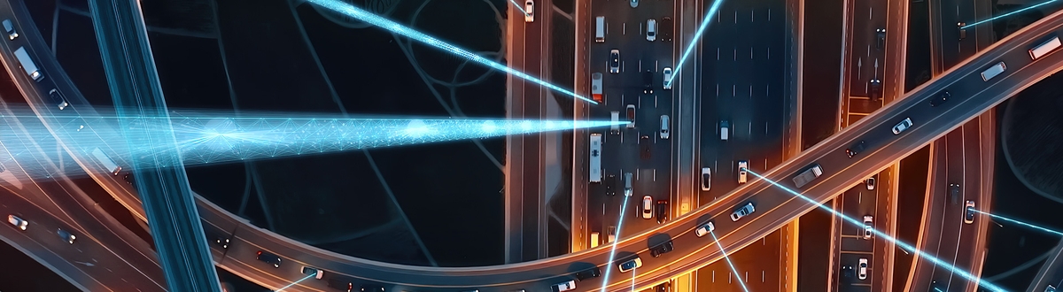 Birds-eye view of motorway at night with abstract graphic to signify connections and data.