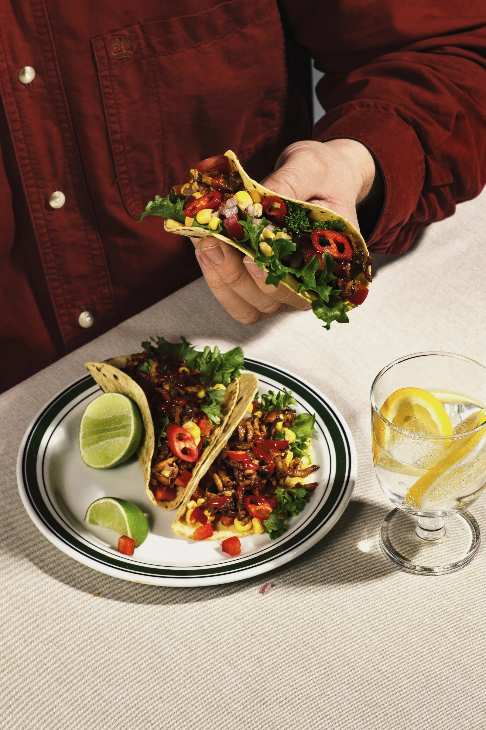 Hands holding a Sloppy Jo's flatwrap mid-bite