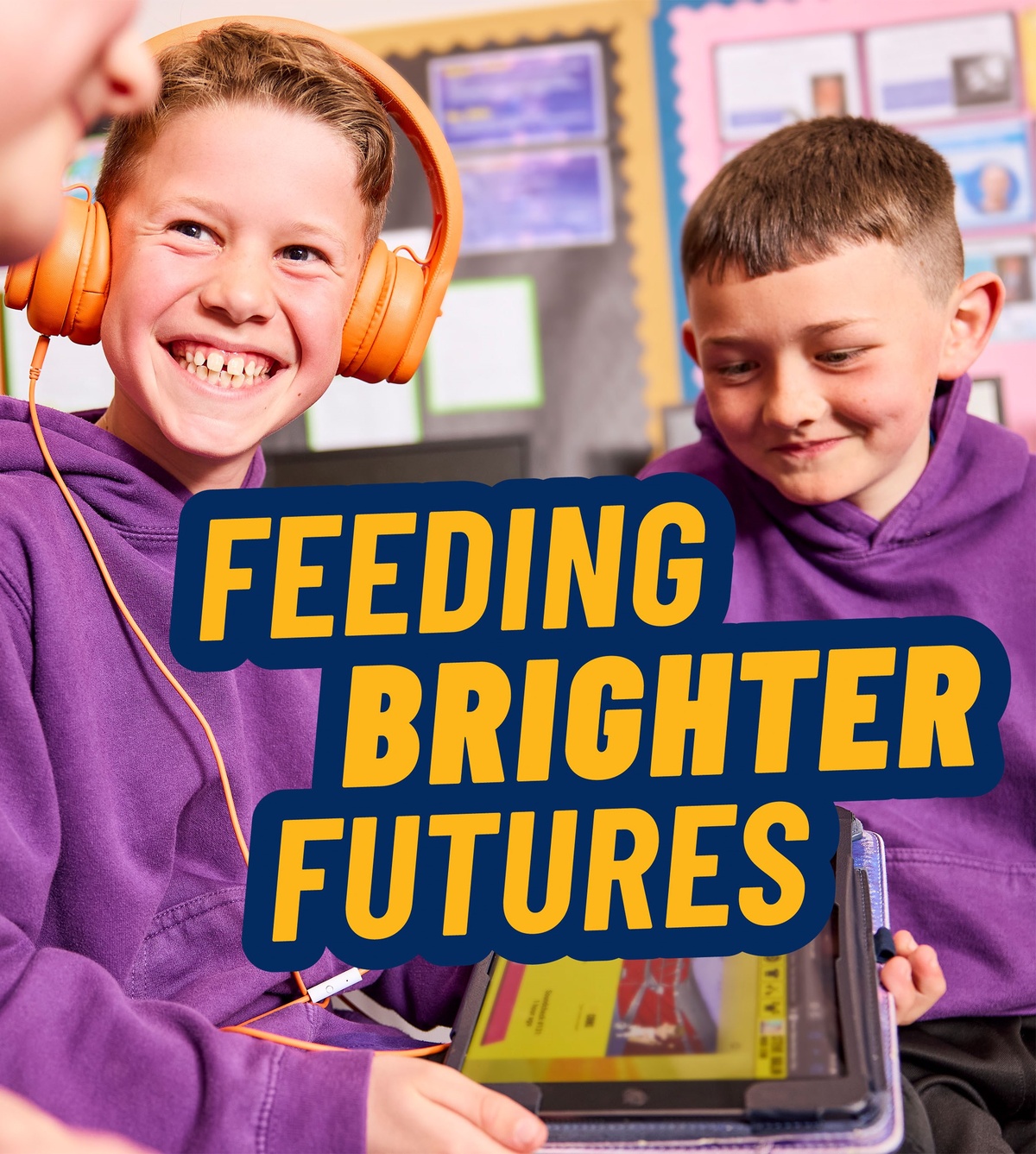 2 boys loo at a tablet computer