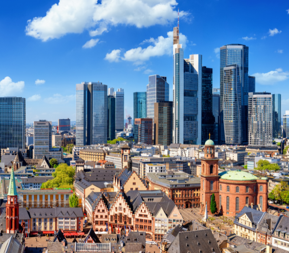 Skyline of Frankfurt, Germany, showcasing a mix of historic buildings and modern skyscrapers under a clear blue sky.