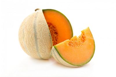 cantaloupe melon with a slice removed and put to the right hand side 