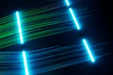 Data represented by luminous lines clustered together by colour. One group is in green, the other is in blue